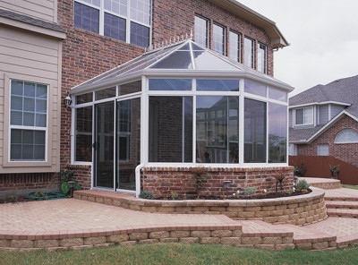 White interior and exterior with glass transoms on brick basewall