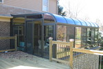 Curved Eave Glass Roof Design Bronze with glass kickpanels and slider door