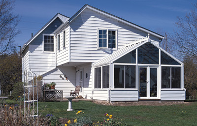 White interior and exterior with glass trapezoids and vinyl siding basewall